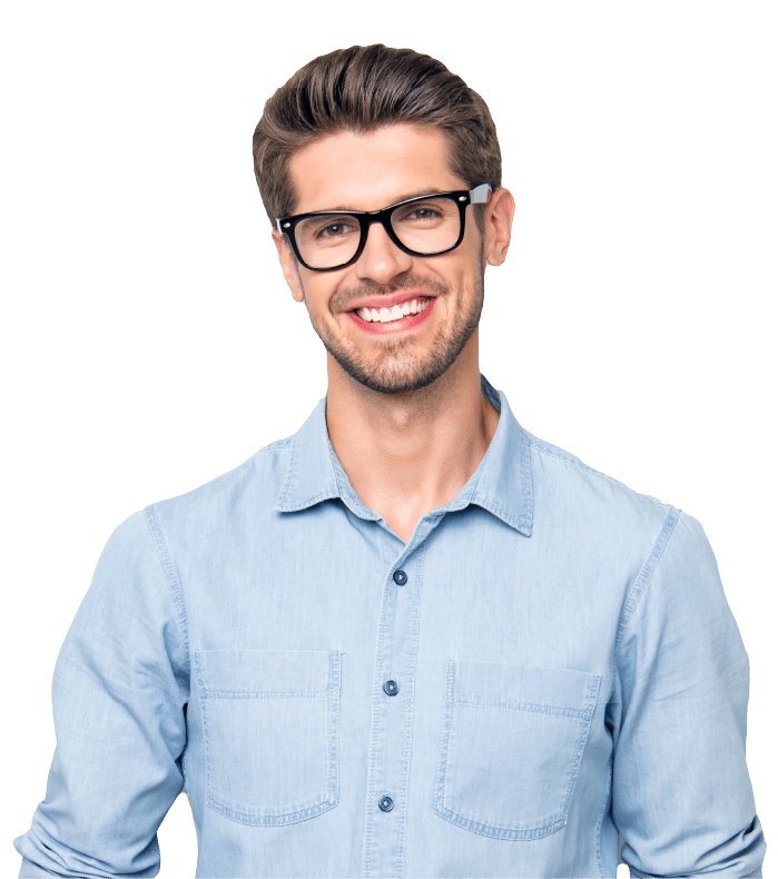 Smiling young man with short brown hair and glasses, wearing a light denim button-up shirt, standing against a plain white background.